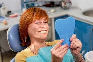 Smiling senior woman new dental implants