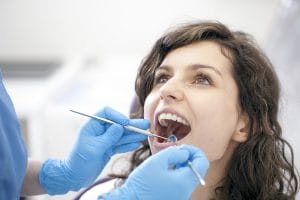 Beautiful woman with dentist doing dental work